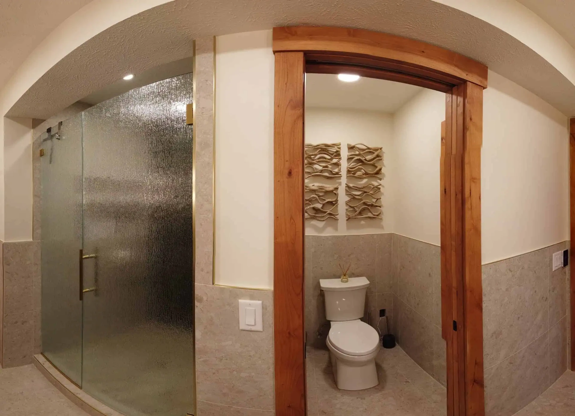 Stone tile bath with rain glass shower enclosure and cherry trim