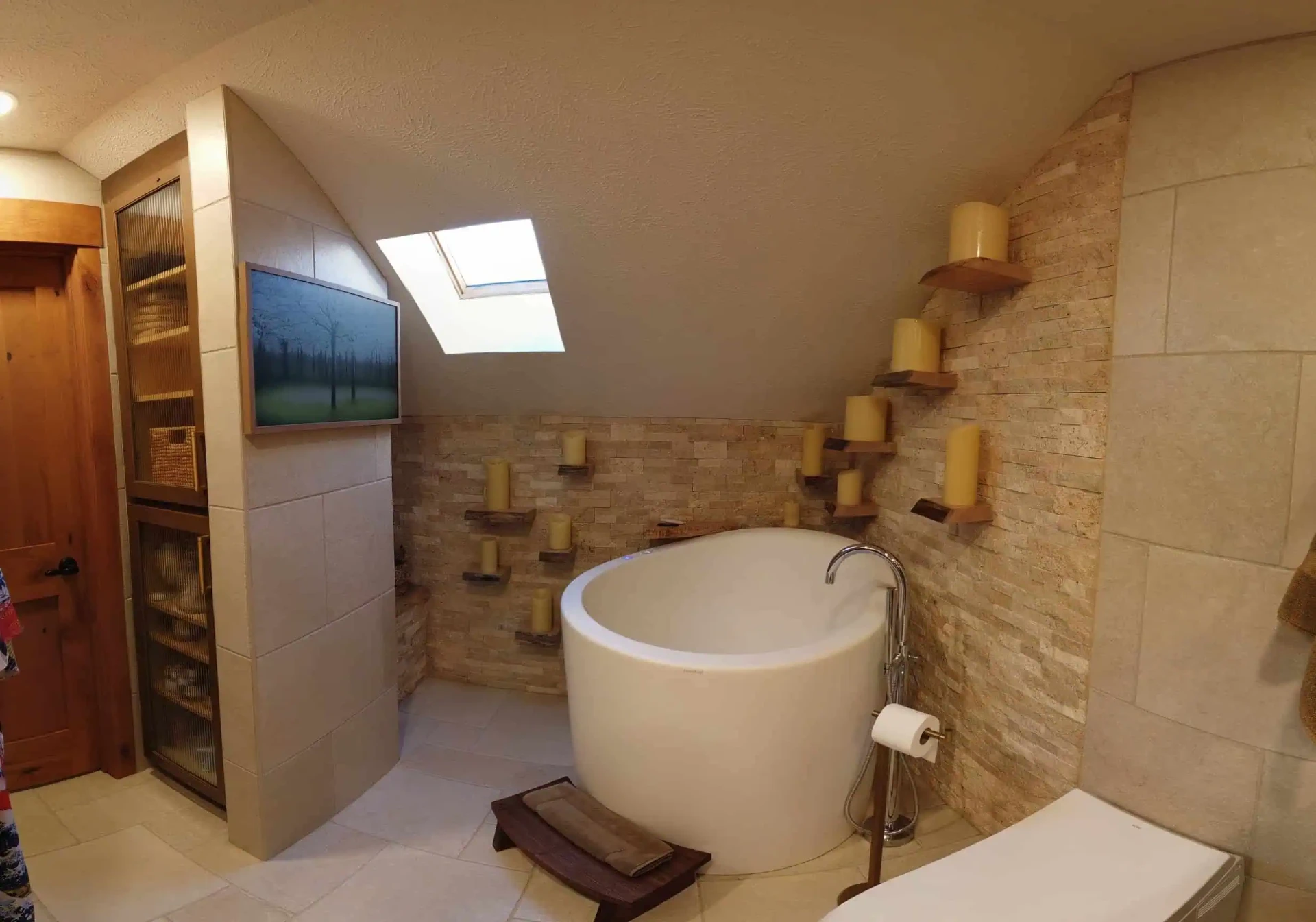 Attic spa bath with japanese soaking tub, skylight, and candle ledges