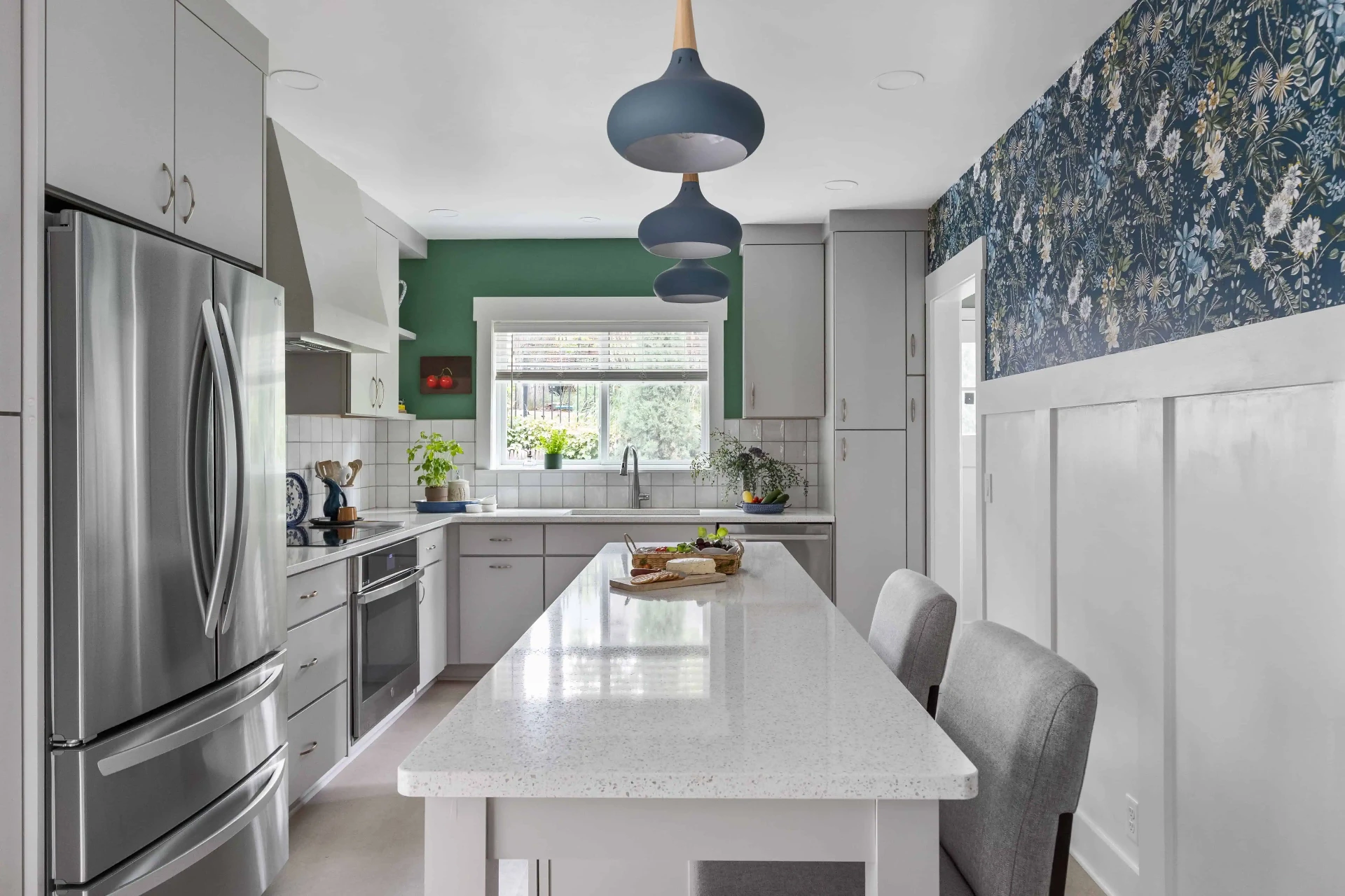 Remodeled Omaha kitchen with light cabinetry, quartz island, and blue pendant lighting