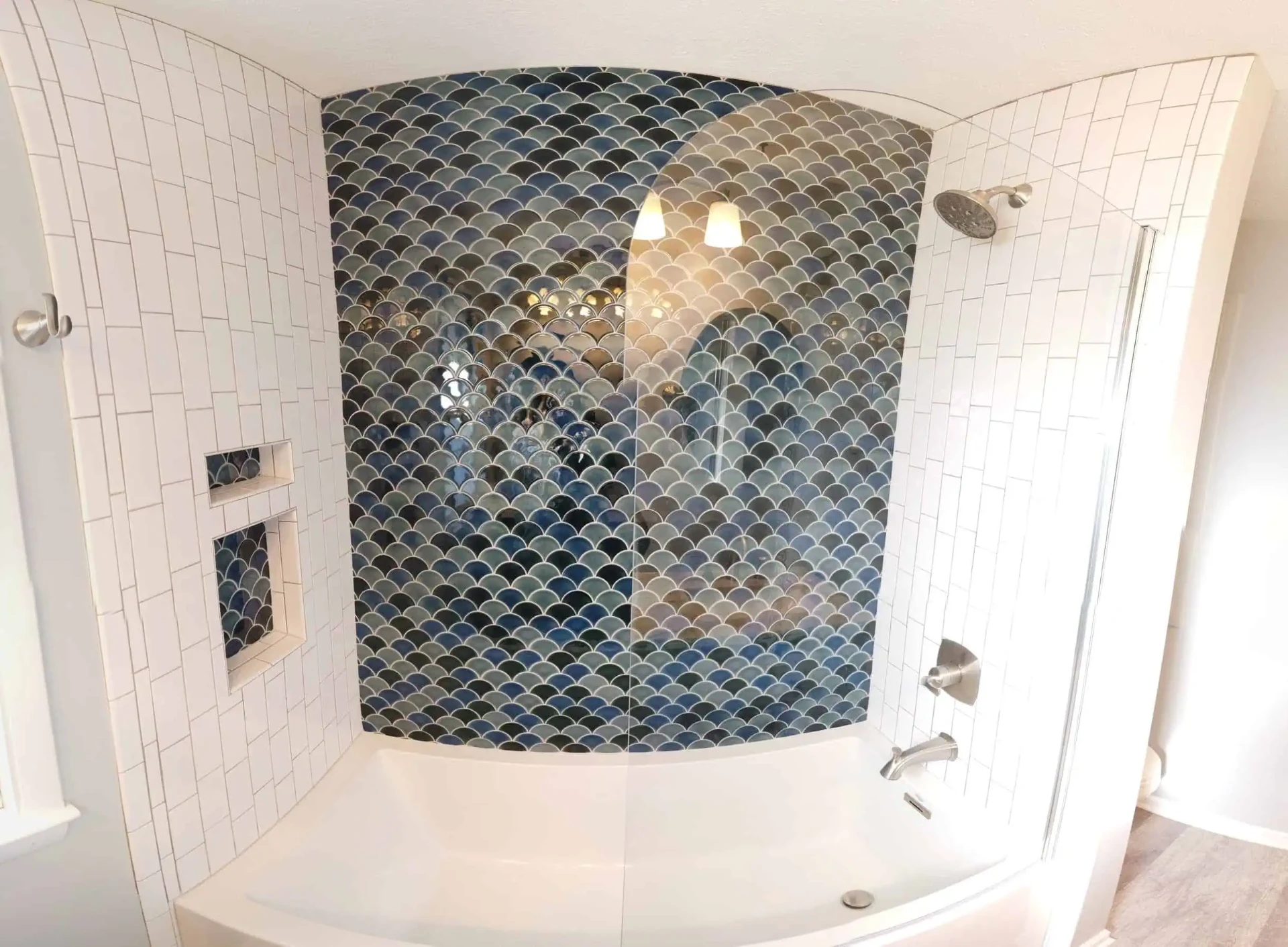 Blue fish-scale tile tub shower with recessed niches