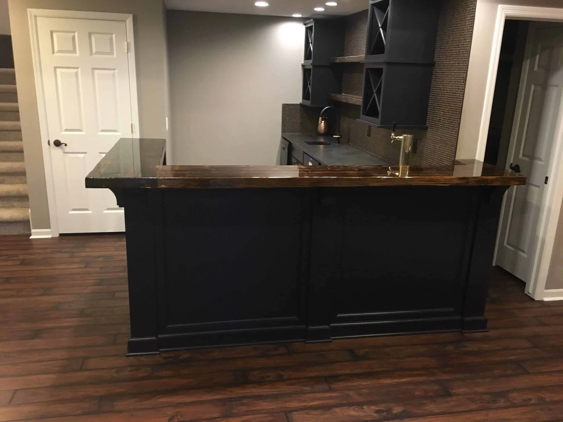 Custom navy bar with live-edge stained top and brass tap tower